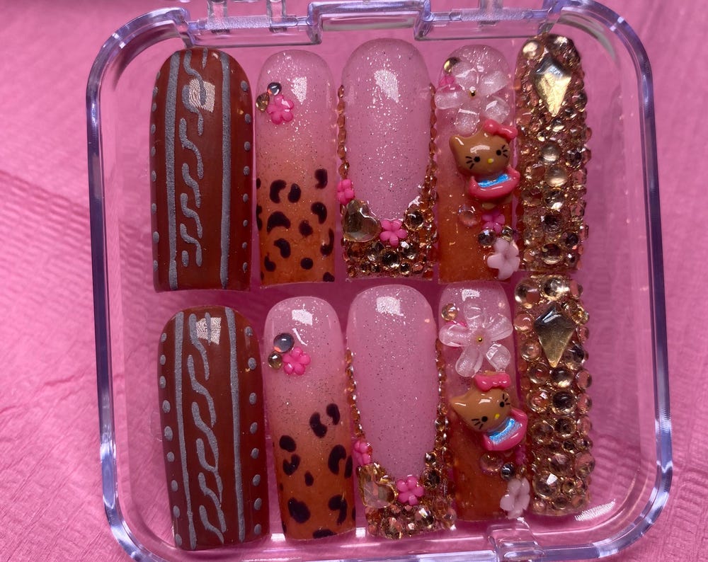 Brown hello kitty press on nails with textured sweater design